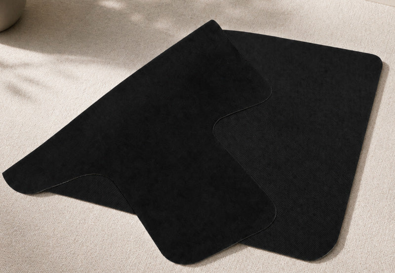 A folded reformer mat on a beige carpet