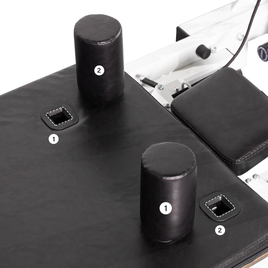 Close-up of the black reformer carriage with two shoulder rest positions.