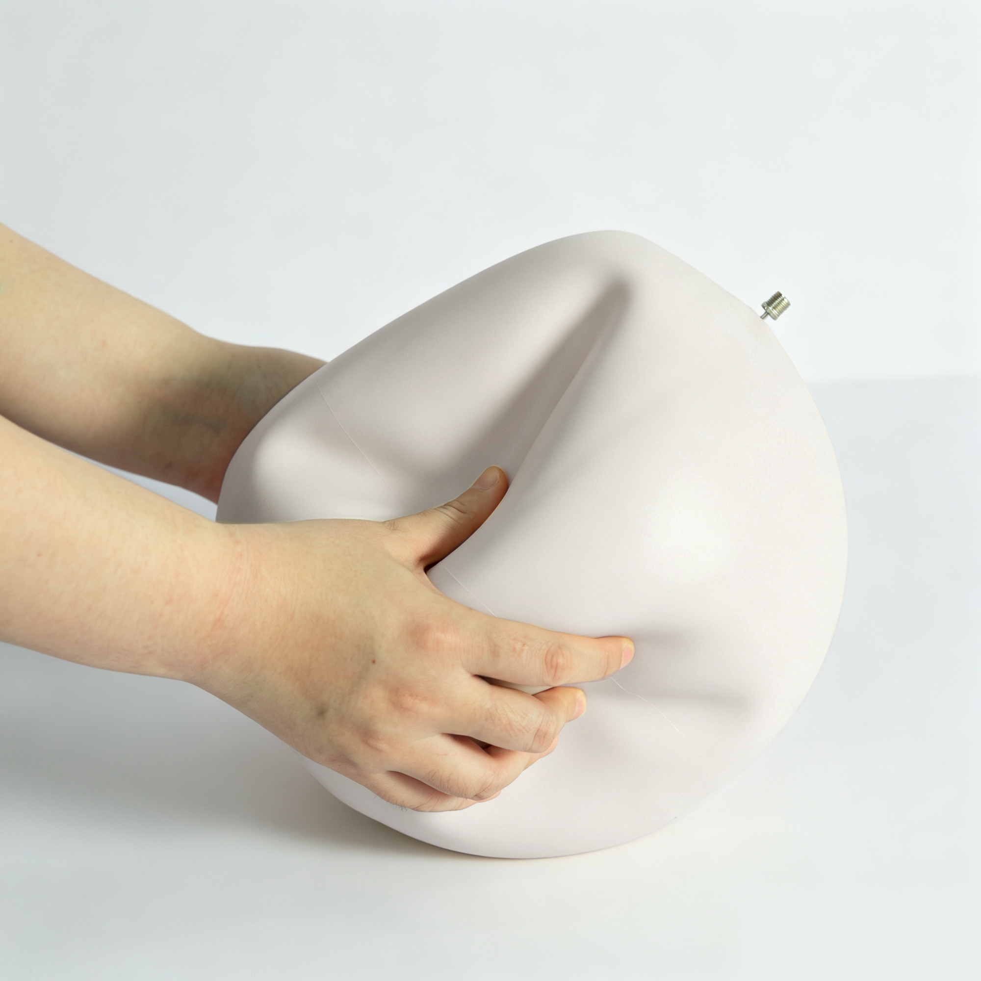 Using an air pump nozzle to deflate a Pilates ball